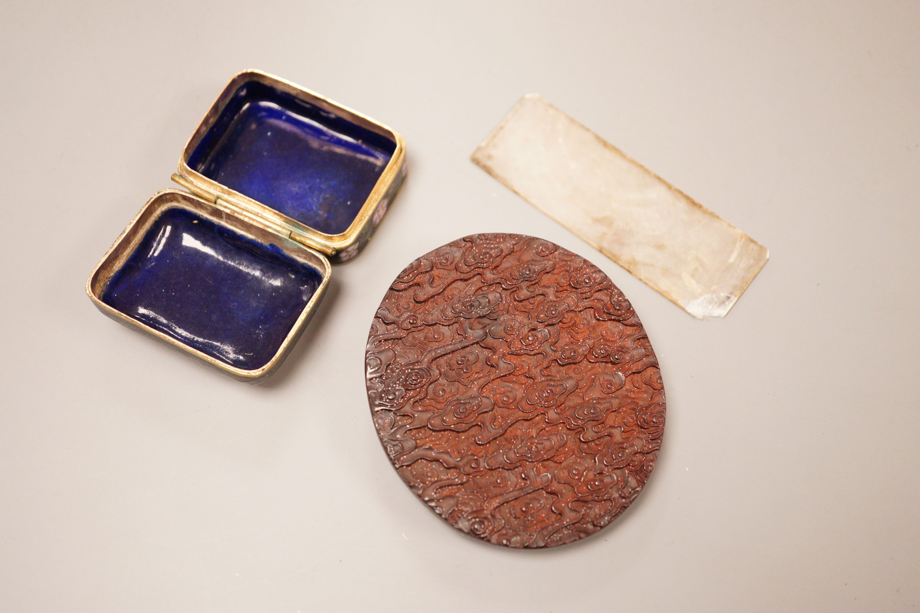 A Chinese cloisonne box, a lacquer carving and a mother of pearl counter